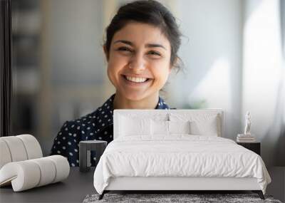 Cheerful indian girl standing at home office looking at camera Wall mural