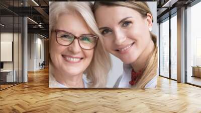 Close up attractive women faces smile look at camera, aged mother young daughter, different generations good warm relations concept horizontal banner for website header design with copy space for text Wall mural