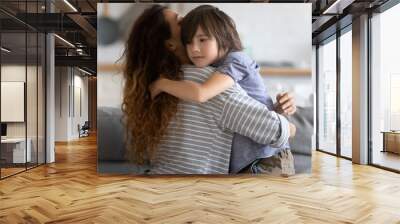 Close up caring young mother hugging preschool upset son. Lovely mom embracing and supporting child in difficult times. Stressful kid asking help from mum. Wall mural