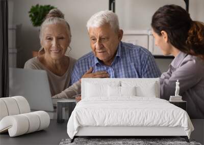 Close up female realtor manager real estate agent consulting mature couple about mortgage or rent, looking at laptop screen, senior family wife and husband listening to financial advisor broker Wall mural