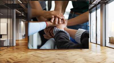 Close up multiracial business people putting hands together, showing support and unity. Diverse colleagues joining in team building activity, staff training concept, start working together, teamwork. Wall mural