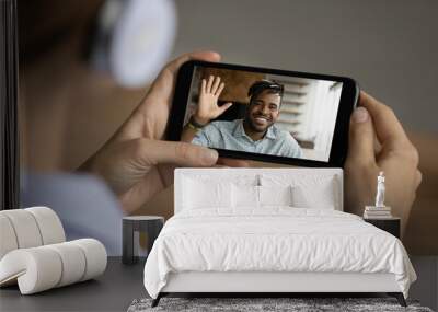 Close up of woman talk speak on video call on smartphone with smiling African American male colleague. Female have webcam online digital virtual conversation with ethnic friend. Technology concept. Wall mural