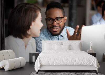 Creative african american and caucasian workers discussing work chatting Wall mural