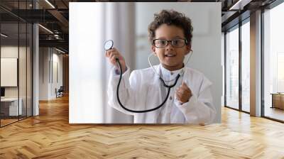 Cute african kid boy wear medical uniform playing doctor, portrait Wall mural