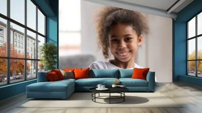 Cute funny little african american girl looking at camera, smiling mixed race child posing for portrait at home, preschool positive black kid with happy face headshot, orthodontic malocclusion Wall mural