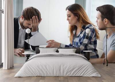 Dissatisfied wife have dispute with realtor or broker in office discussing contract mistakes or terms, consultant feel annoyed or bothered by angry woman proving document incorrect at meeting Wall mural