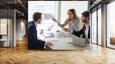 Diverse business partners disagree with company CEO on contract terms, people have dispute or fight at meeting in office, associates or colleagues argue at briefing failing cooperation or partnership Wall mural