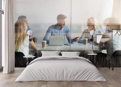 Diverse business people negotiating at table behind closed glass door Wall mural