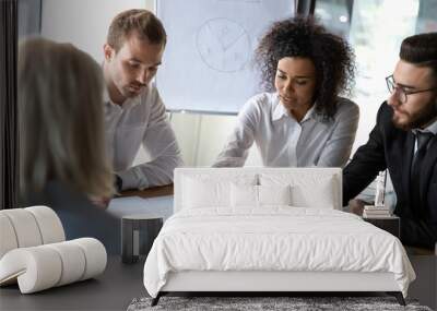 Diverse employees discussing business strategy, working on project together Wall mural