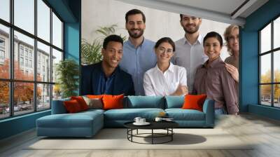 Diverse happy business people successful employees team posing in office, looking at camera, smiling workers group, motivated staff, confident businesswomen and businessmen corporate portrait Wall mural