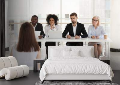 diverse hr managers listen to female job candidate speaking during work interview in office, multiet Wall mural