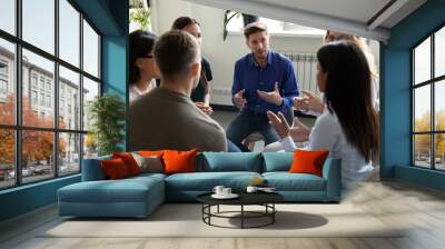 Diverse people seated in circle participating at group therapy session Wall mural