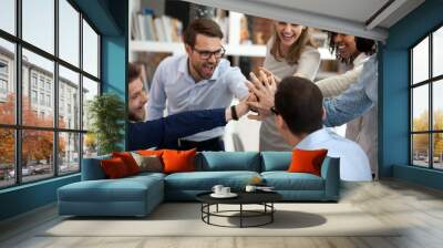 Excited motivated multi-ethnic team people give high five in office Wall mural