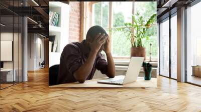 Frustrated African American worker disappointed with company business collapse, falling rates and bankruptcy news. Upset black student fail exam. Concept of failure, losing hope and stress Wall mural