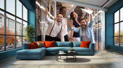 Funny multiethnic employees posing for picture in office hallway Wall mural