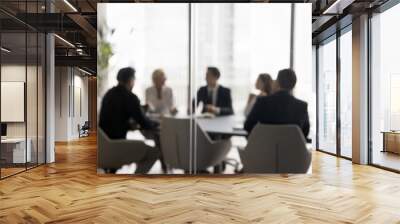 Group of businesspeople negotiating gathered in modern conference room, blurred silhouettes view, meeting behind closed glass doors. Business communication, workflow, decision-making, strategy sharing Wall mural