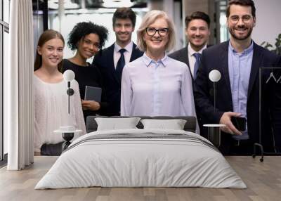 Group picture of smiling multiracial employees team pose together looking at camera in office, happy diverse multiethnic colleagues show unity and motivation at work, career, employment concept Wall mural