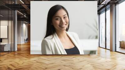 Happy Asian office worker in formal wear smiling to camera posing for company business catalogue, making portrait photo. Confident businesswoman laughing with bright wide smile Wall mural