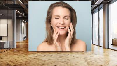 Happy beautiful woman smile touching clean face skin Wall mural