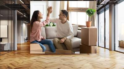 Happy couple give high five celebrate moving into new home Wall mural