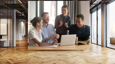 Happy diverse office workers team laugh work together at meeting Wall mural