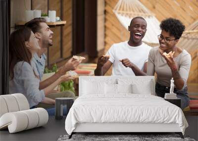 Happy diverse young people eating pizza having fun Wall mural