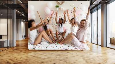 Happy ladies throw confetti up sit on bed celebrate party Wall mural