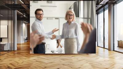 happy manager boss praising old employee get team appreciation Wall mural