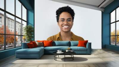 Happy millennial Afro American business woman in casual glasses posing isolated on white, smiling with perfect white teeth. Confident female customer, professional head shot portrait Wall mural