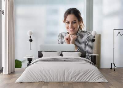 happy smiling young woman looking at laptop screen. excited businesswoman received good business off Wall mural