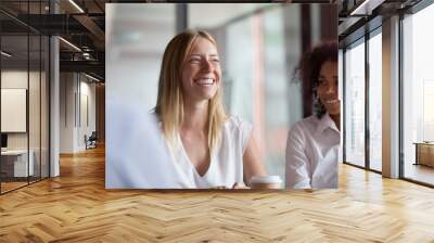 Happy young businesswoman coach mentor leader laughing at group meeting Wall mural