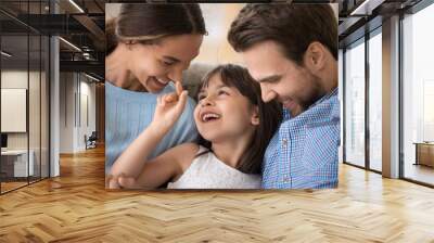 Happy young family with kid relax having fun at home Wall mural