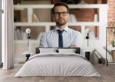 Head shot portrait confident businessman in glasses standing in office with arms crossed, successful Wall mural