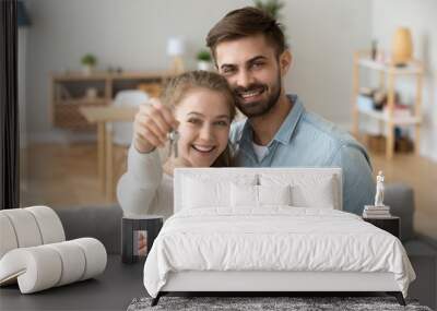 Head shot portrait of happy couple in love holding keys, hugging Wall mural