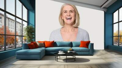 Headshot happy aged female laughing posing on grey studio background Wall mural