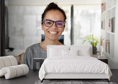 Headshot portrait of happy african American businesswoman in glasses look at camera pose in office, smiling biracial young female employee in spectacles show leadership and success qualities Wall mural