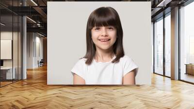 Headshot portrait of happy little girl posing in studio Wall mural