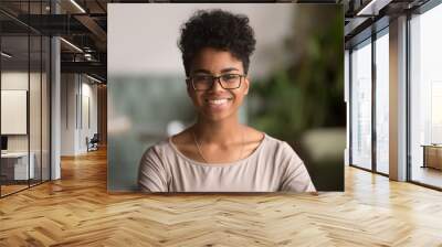 Headshot portrait of happy mixed race african girl wearing glasses Wall mural