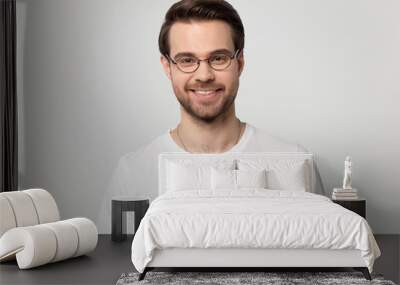 Headshot portrait of smiling man in glasses on studio background Wall mural