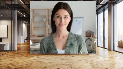 Headshot portrait of smiling young 20s businesswoman stand posing in modern office. Profile picture of happy female employee or worker show leadership and success at workplace. Employment concept. Wall mural