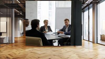 In modern office board room team of young and middle-aged diverse businesspeople take part in group meeting. Morning briefing event, educational seminar lead by coach, negotiations, business concept Wall mural