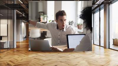 Mad male worker yelling at female colleague asking her to leave office, multiracial coworkers disputing during business negotiations, employees cannot reach agreement, blaming for mistake or crisis Wall mural