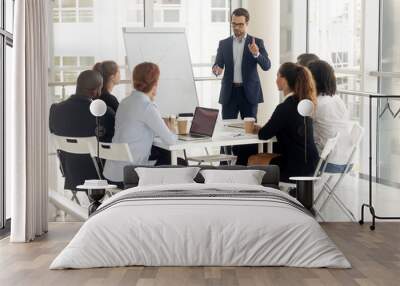 Male coach make whiteboard presentation for diverse employees Wall mural