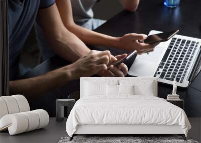 Man and woman using smartphones and laptop, couple holding cellphones discussing mobile apps or sharing information online, cloud data synchronization, people and devices concept, close up view Wall mural