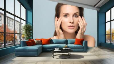 Millennial woman touch healthy skin satisfied with facial treatment Wall mural