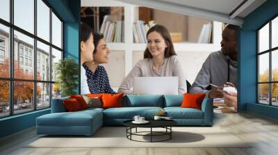 Multi-ethnic students sitting at classroom desk study together Wall mural