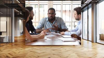 Multinational millennial colleagues gather at office meeting Wall mural