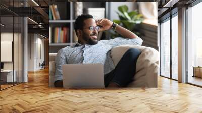 Multiracial freelance guy distracted from job study, looking at window. Wall mural