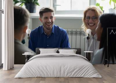 Overjoyed diverse people gather at meeting have fun talking speaking, happy multiracial colleagues patients laugh engaged in teambuilding training or therapy at briefing, help, cooperation concept Wall mural