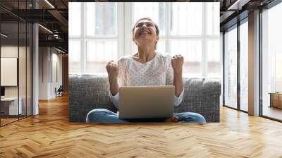 Overjoyed young indian woman celebrating personal achievement. Wall mural